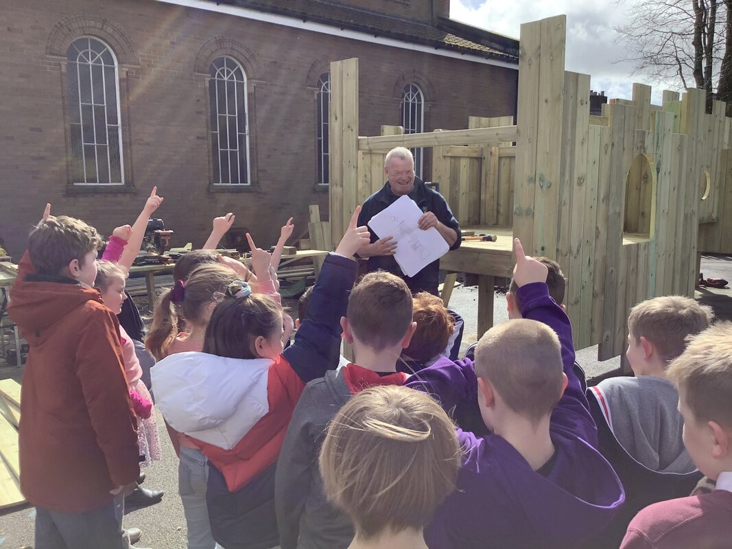 Image of Year 2  enjoy a tool talk from the playground installers
